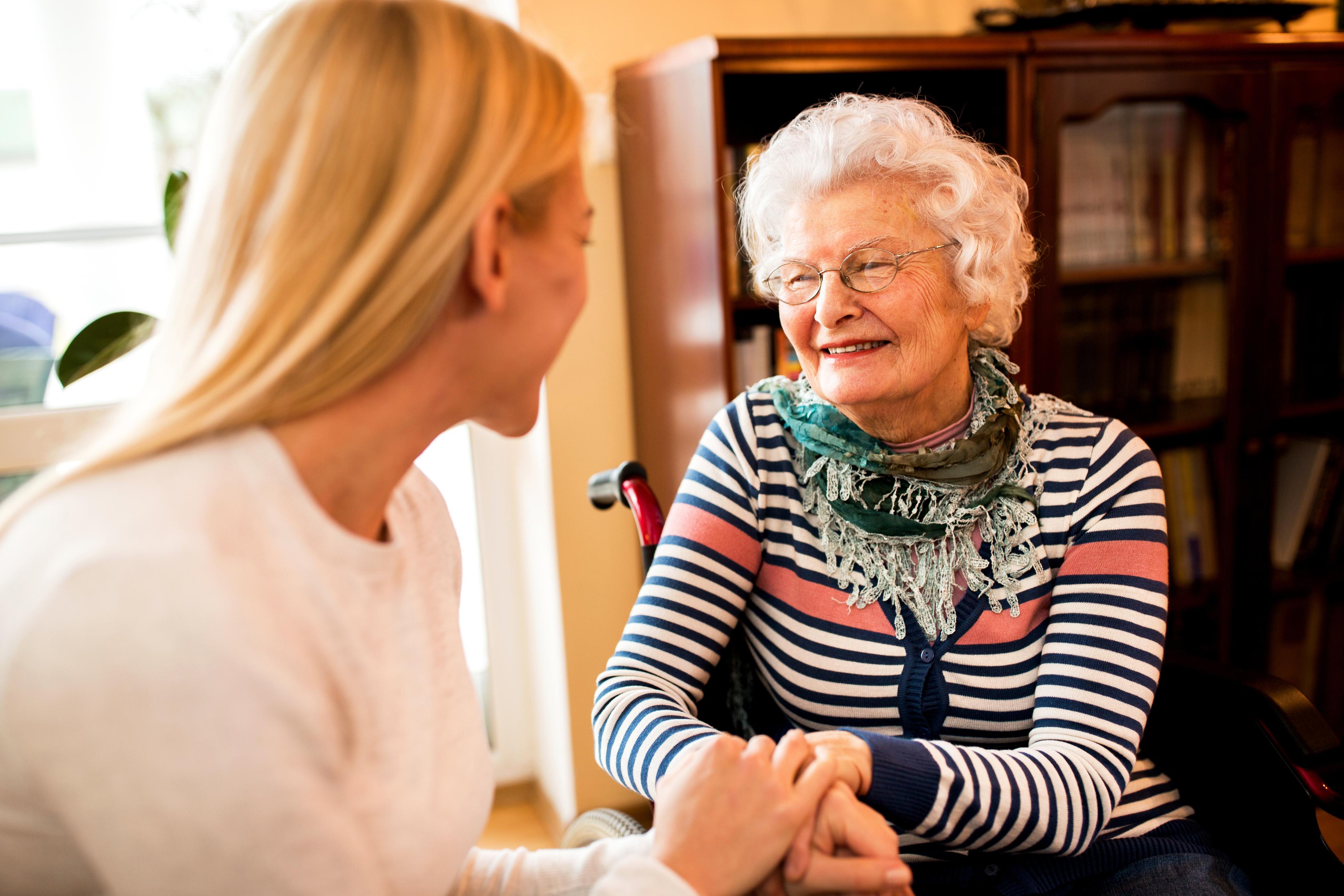Support worker speaking with an older woman at home