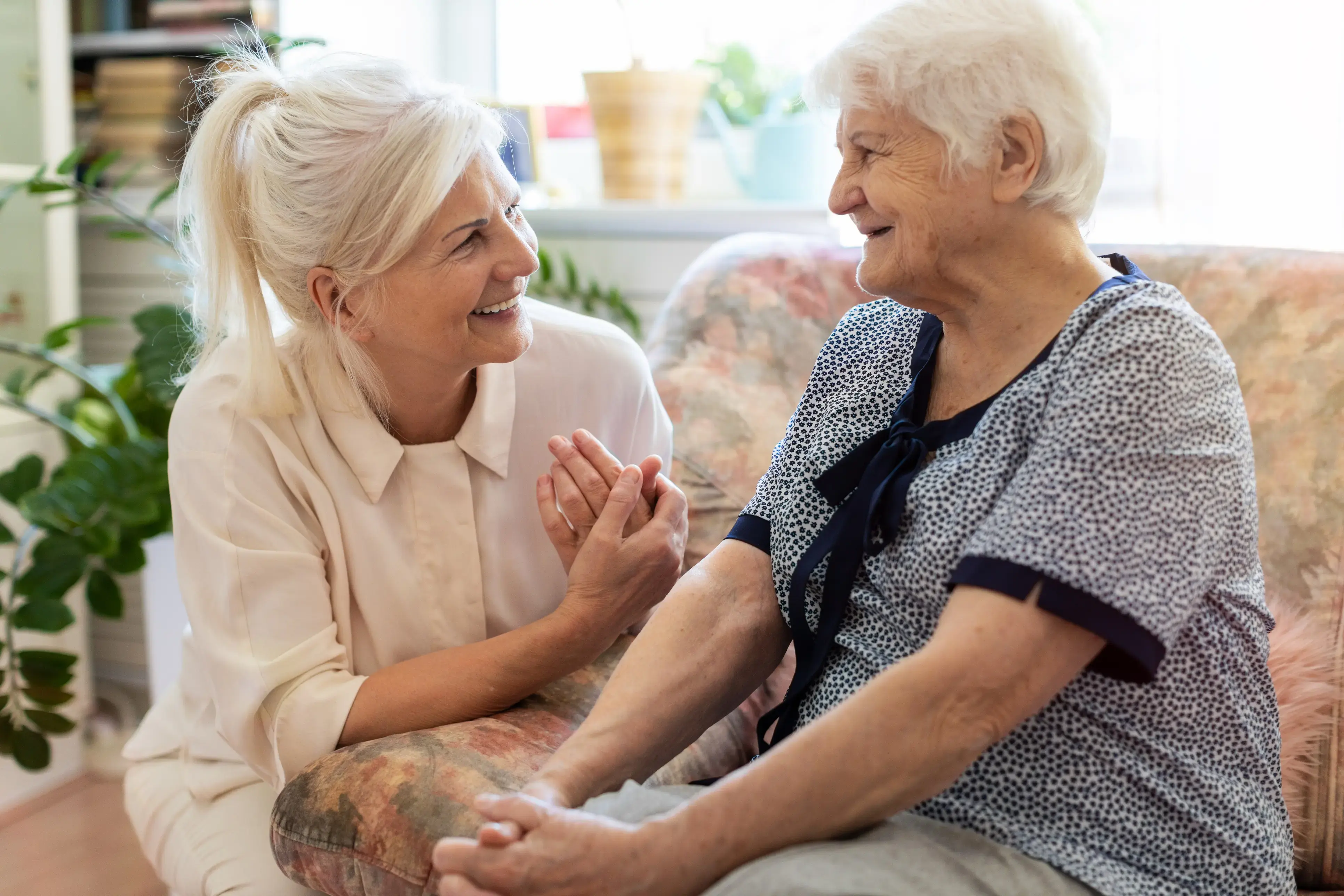 Support worker sitting with an older person at home